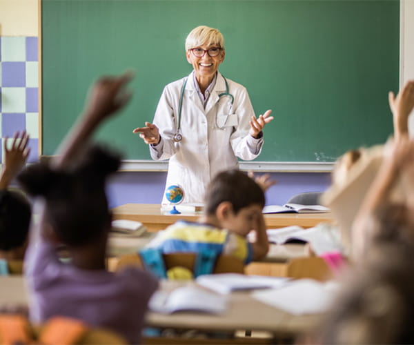 Doctor giving presentation at elementary school