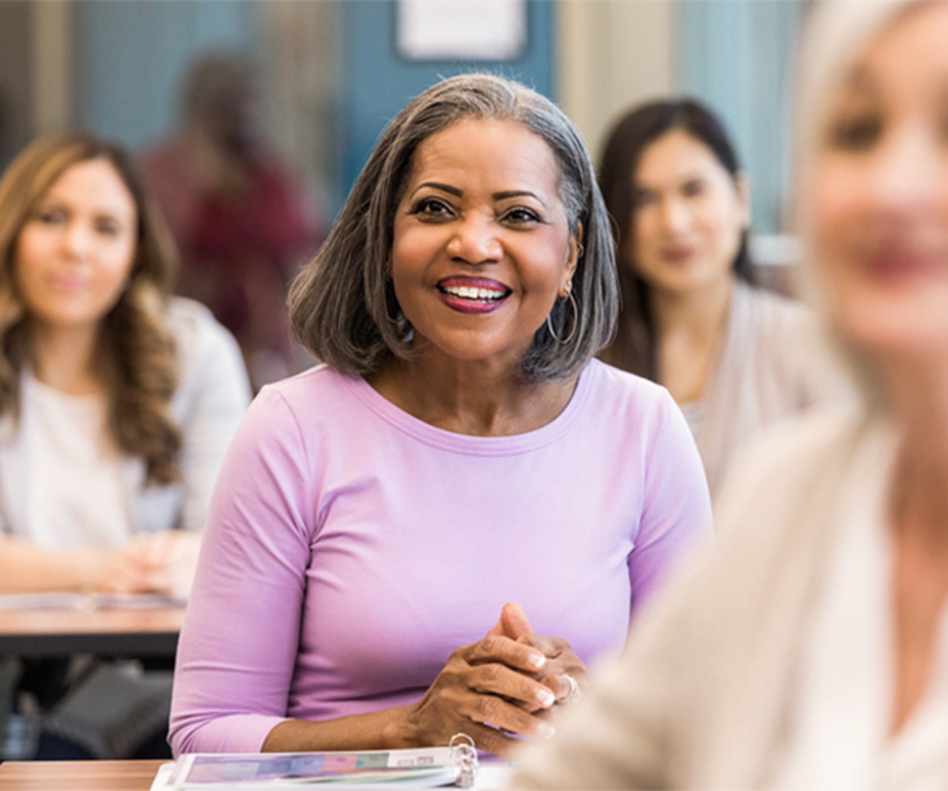 A woman smiling in a classroom