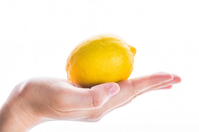 A hand holding a lemon A hand holding a lemon