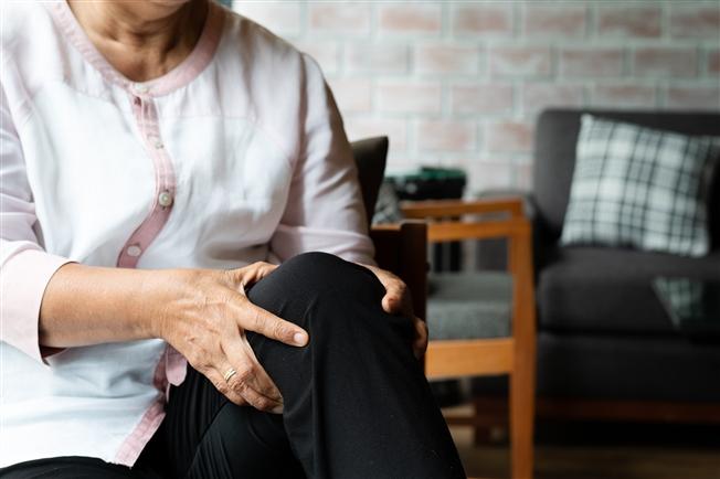 Woman clutching knee in pain