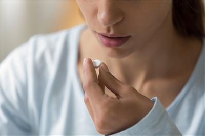 Up close of a woman about to take a pill Up close of a woman about to take a pill