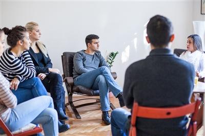 Woman speaking in group therapy session Woman speaking in group therapy session