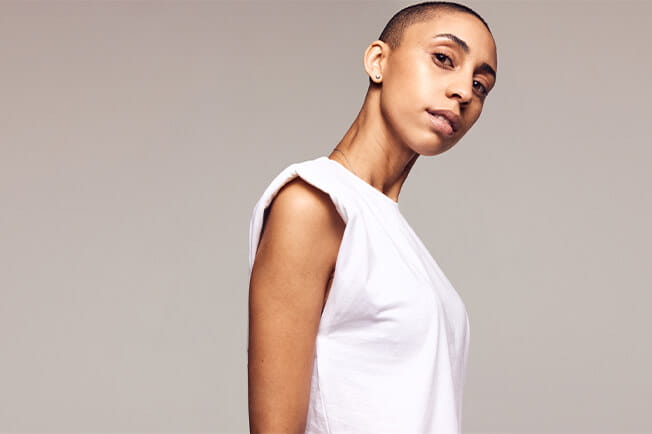 Androgynous person with shaved head