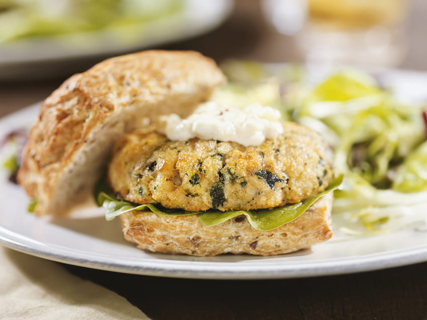 Salmon burger on whole wheat bun with garlic aioli.