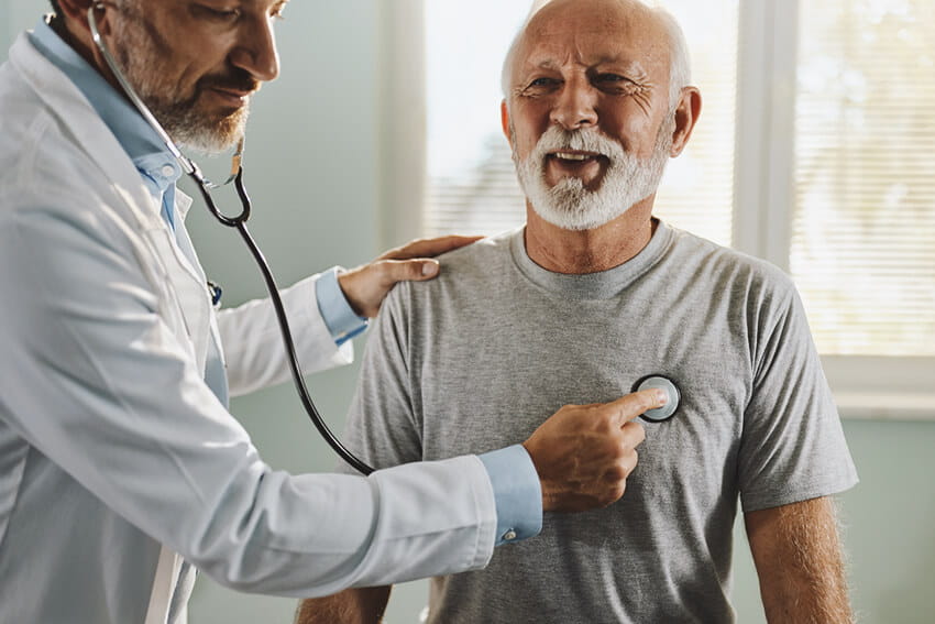 A doctor listening to a patient's heart.