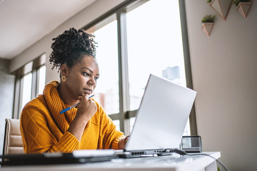 Woman on her laptop at home.