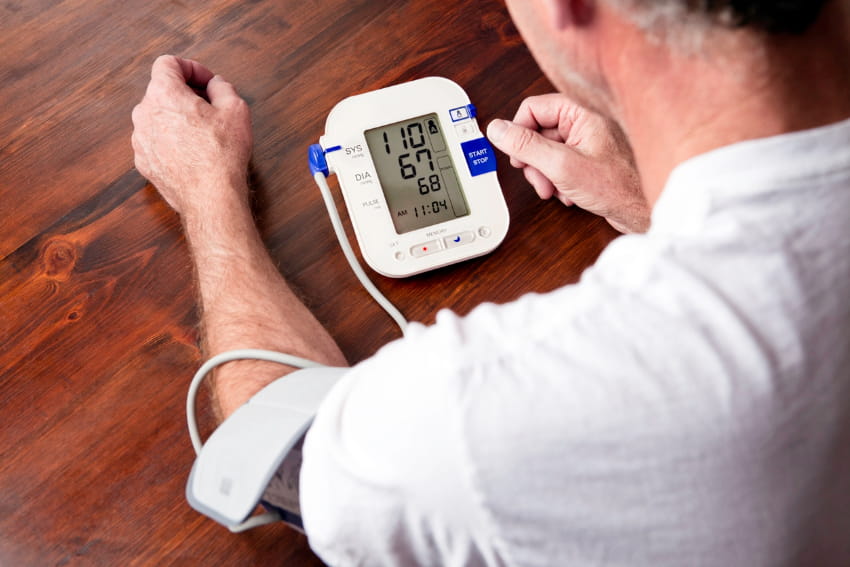 man checking blood pressure at home