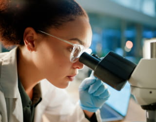 Scientist, microscope and analysis in lab for medical study