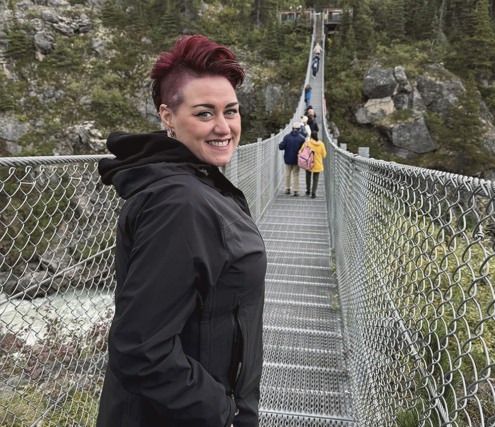 Amy standing on a bridge