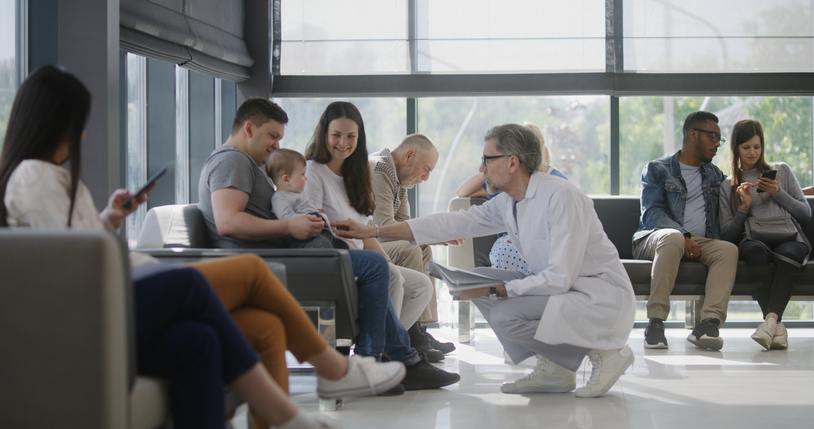 Doctor talking to patient family in waiting area