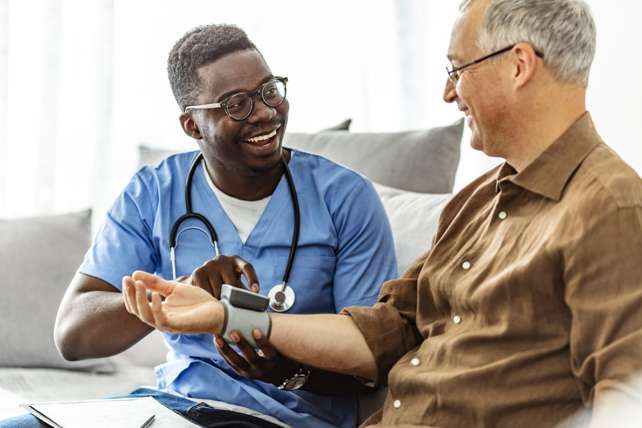 Homecare nurse takes patient's blood pressure