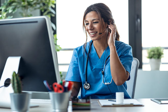 Woman with headset on at computer desk