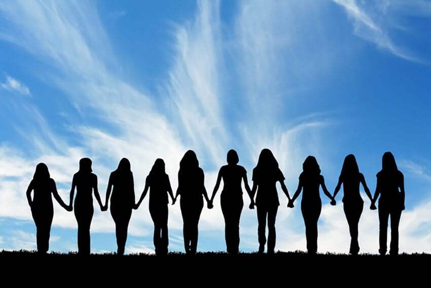 Silhouette of women holding hands