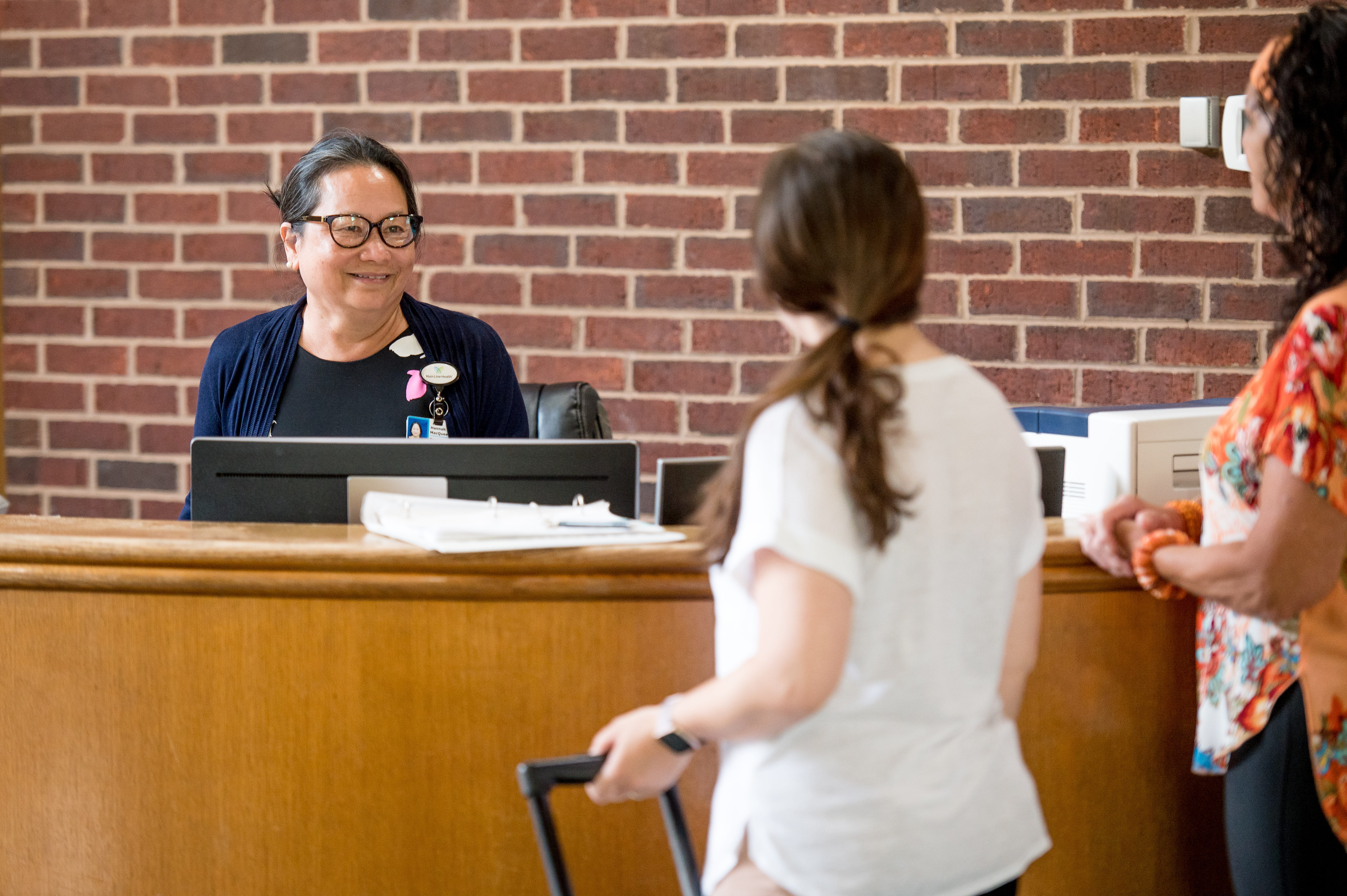 women at admissions counter