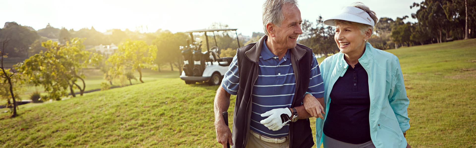 man and women walking on golf course