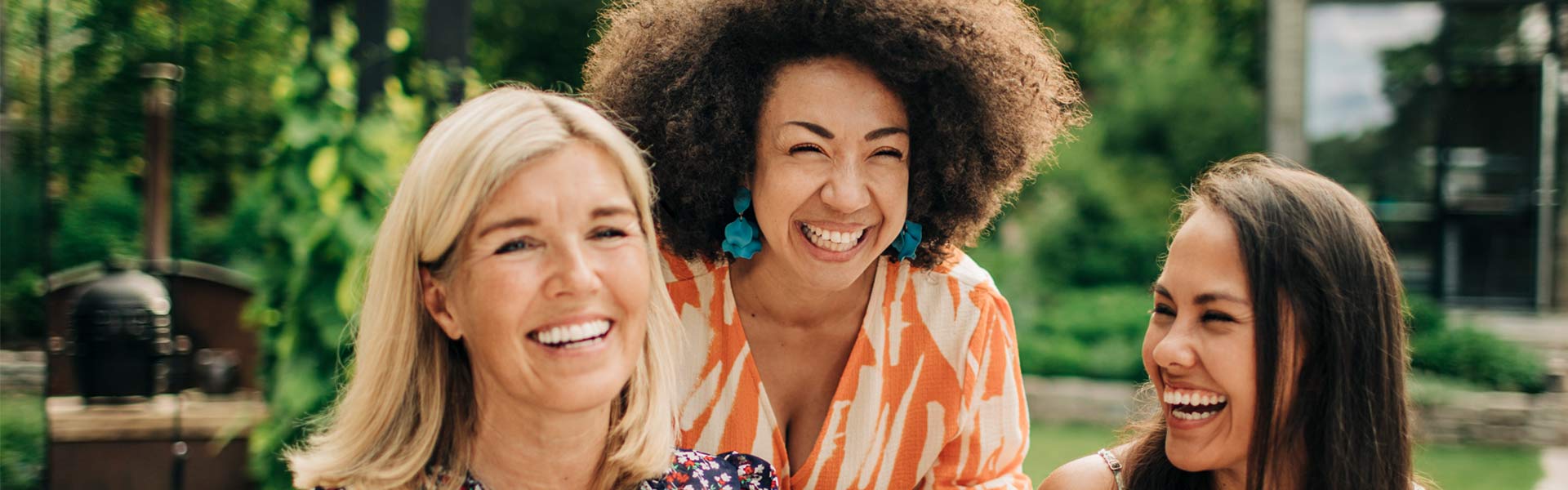 three women smiling and laughing