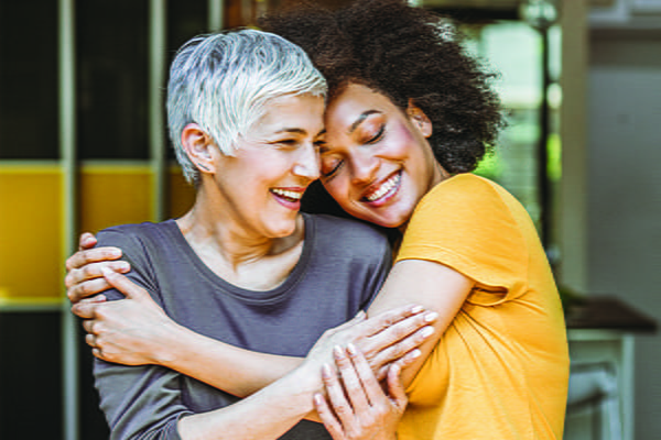 A mother and daughter hugging.